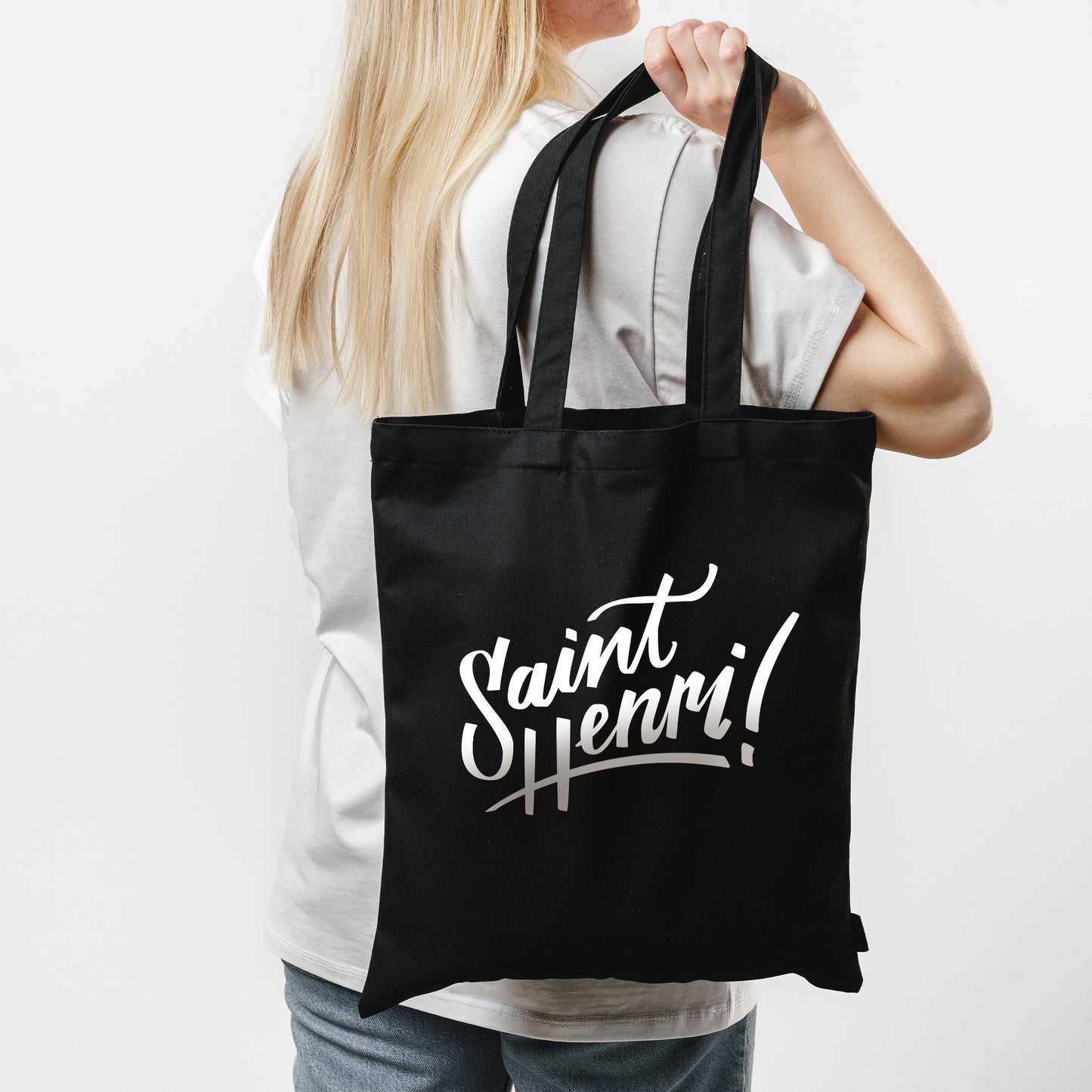 woman holding black tote bag, saint-henri logo, black bag, white imprint, printed in montreal