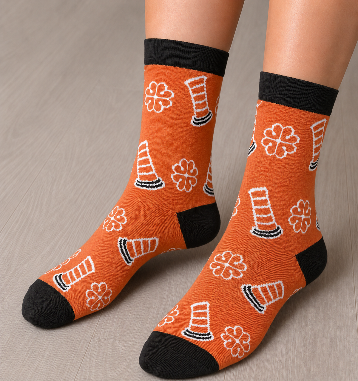 A person wearing the orange socks with traffic cone designs.