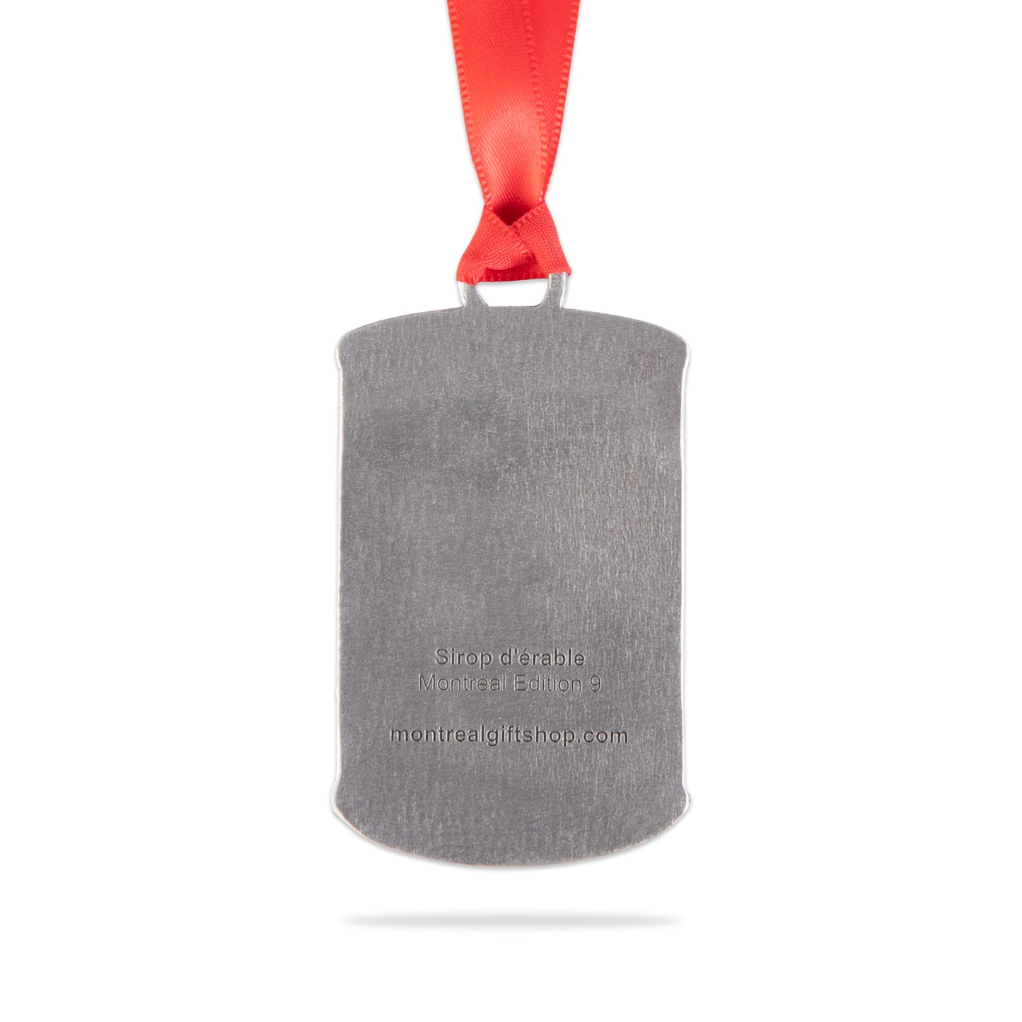 back of maple syrop can ornament with red ribbon