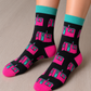 A person wearing two socks with designs of the Little Pink house in Montreal.