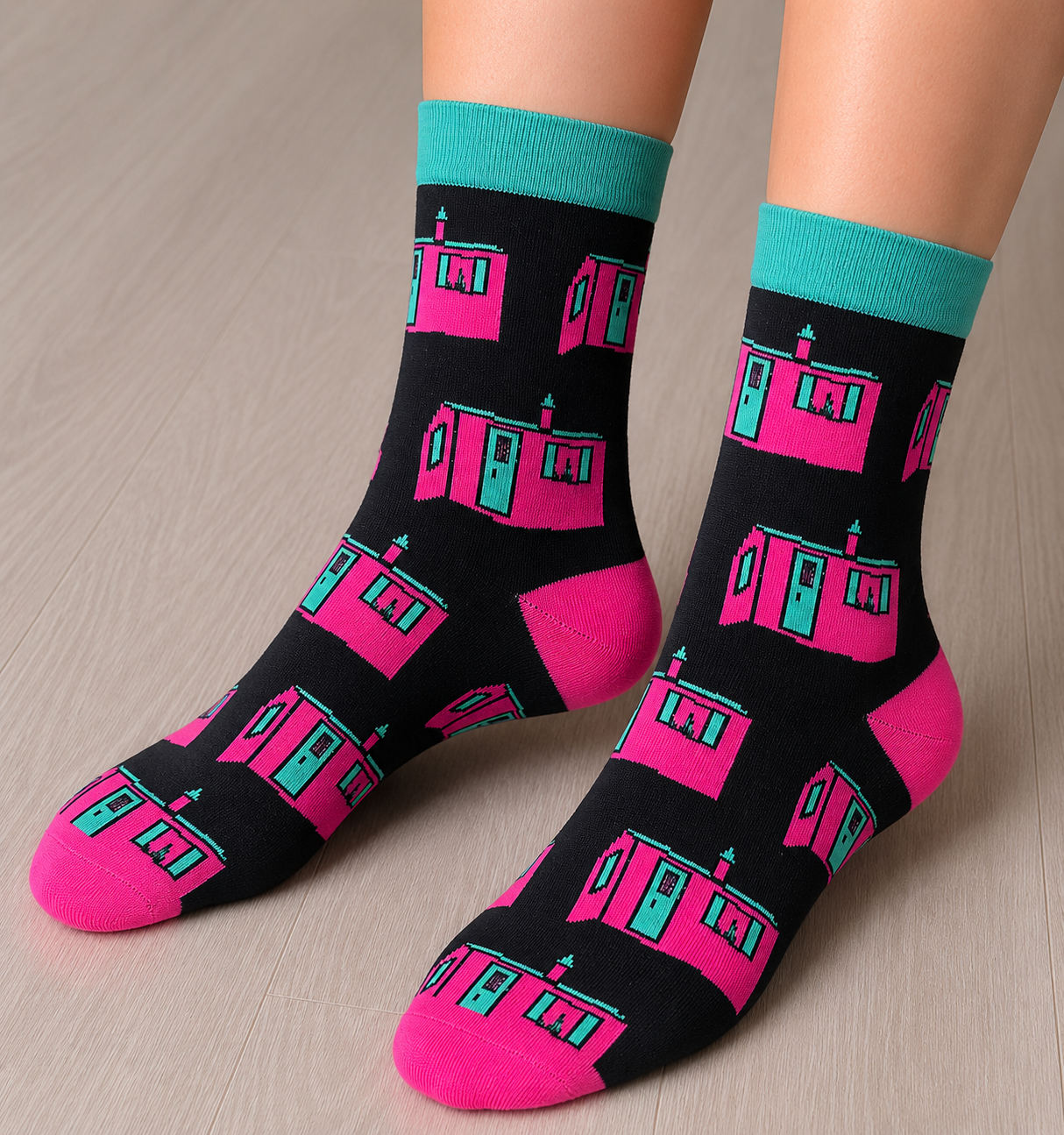 A person wearing two socks with designs of the Little Pink house in Montreal.