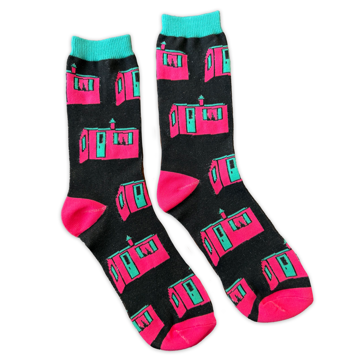 Two socks on a white background, they are black with a design of the iconic Little Pink house in Montreal.