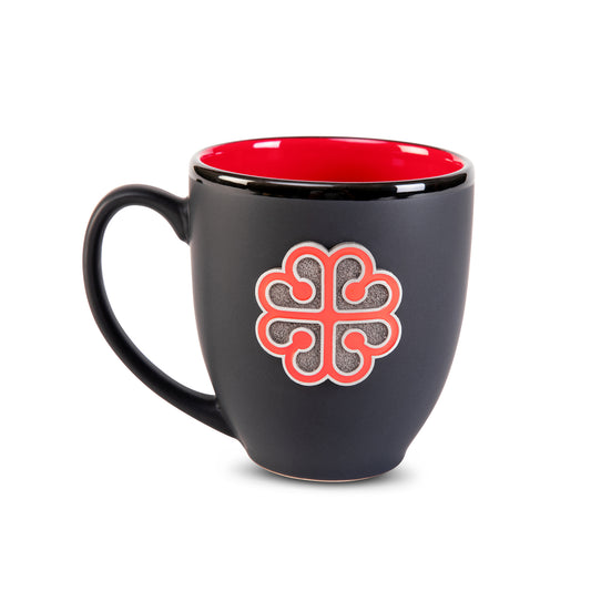 Black mug with red interior and decorative pewter crest of montreal logo on a white background