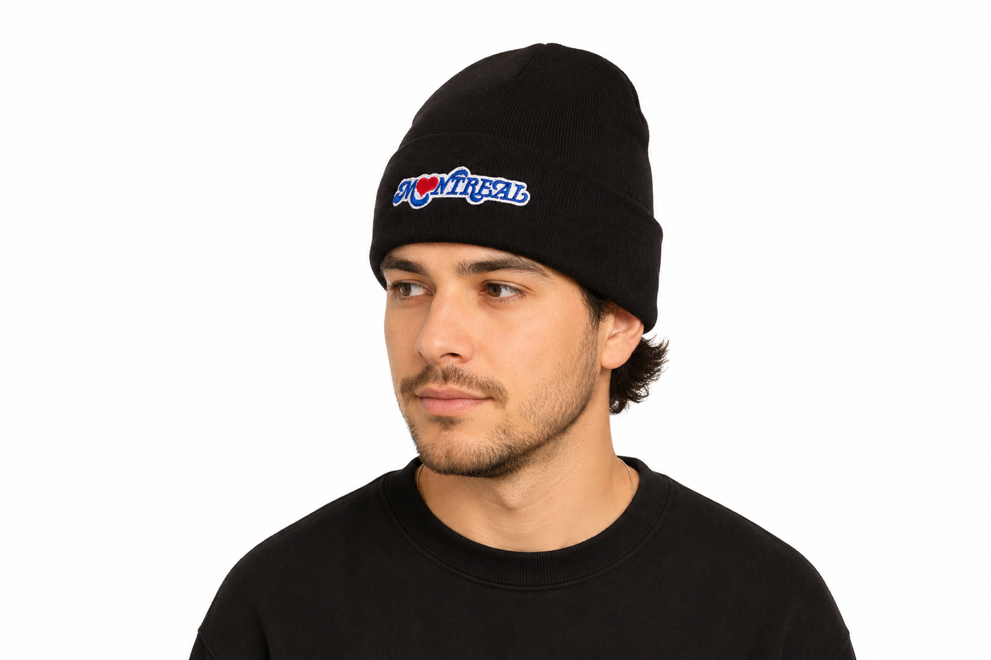 A man wearing a black tuque with the Montreal Love design embroidered on the front. 