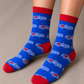 Person wearing two socks, they are blue and red with the Montreal Love design. 