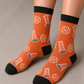 A person wearing the orange socks with traffic cone designs. 