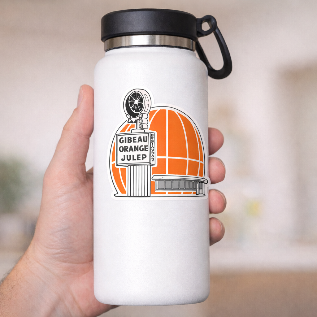White insulated mug with gibeau orange julep sticker held by a hand against a blurred background