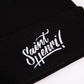 A closeup of a black tuque with the Saint-Henri design embroidered on the front. 